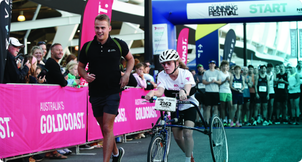 Tarsha with Cerebral Palsy running alongside Charlie, owner of Exercise Therapies, at the Gold Coast Marathon