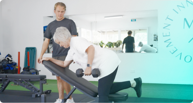 Robyn and Charlie from Exercise Therapies lifting weights, focusing on strength training